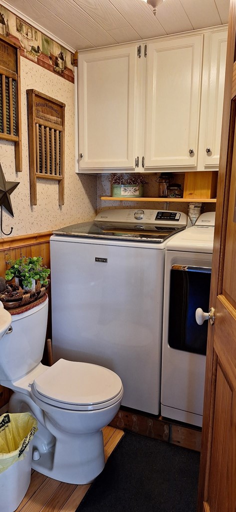 607 N W St, Coudersport, PA 16915 - half bath featuring independent washer and dryer, toilet, and wallpapered walls