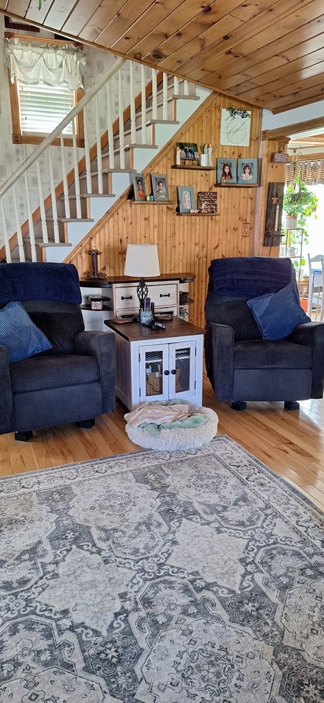 607 N W St, Coudersport, PA 16915 - living area featuring wood finished floors, stairs, wood walls, and wooden ceiling