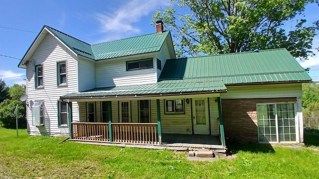 2323 Cotton Hollow Rd, Athens, PA 18810 - rear view of property featuring covered porch, metal roof, a chimney, and a yard