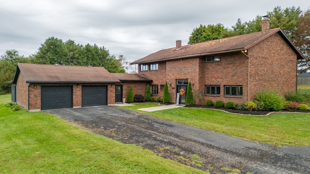 view of front of house with a front yard and a garage