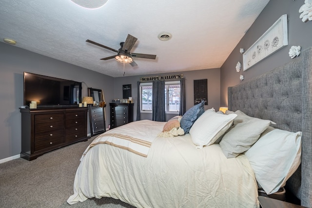 bedroom featuring a textured ceiling, ceiling fan, and light carpet