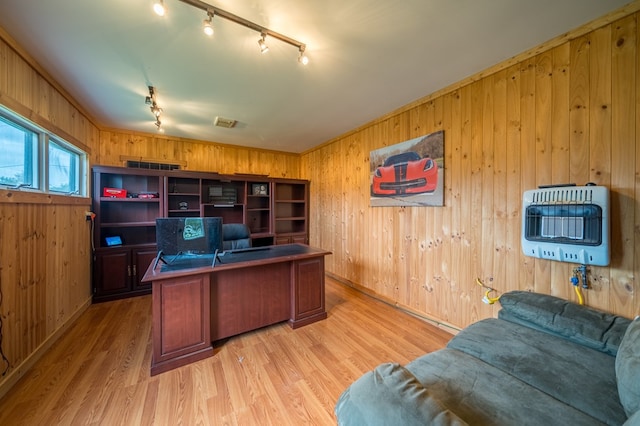 office with heating unit, track lighting, and wood walls