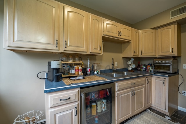 kitchen with light brown cabinets, sink, and wine cooler