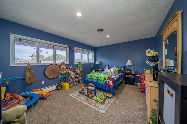 bedroom featuring carpet floors, a textured ceiling, and multiple windows