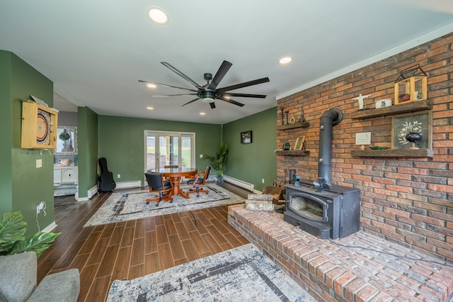 living room with a wood stove and ceiling fan