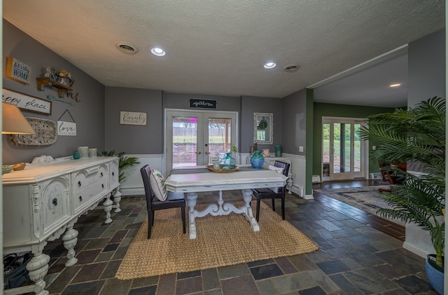 dining room featuring a textured ceiling and french doors