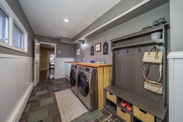 laundry room with cabinets, independent washer and dryer, and wet bar