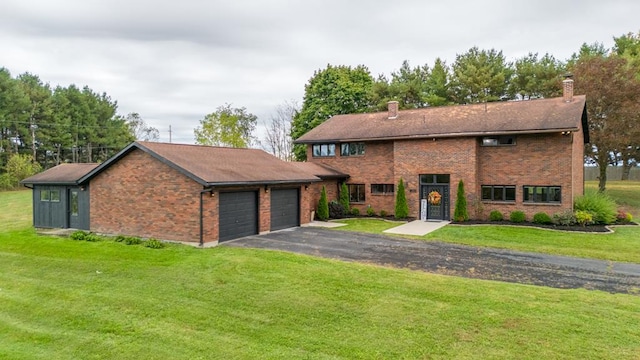 view of front of property featuring a front yard and a garage