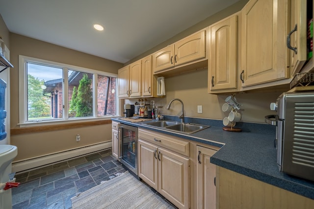 kitchen with light brown cabinets, a baseboard radiator, beverage cooler, and sink