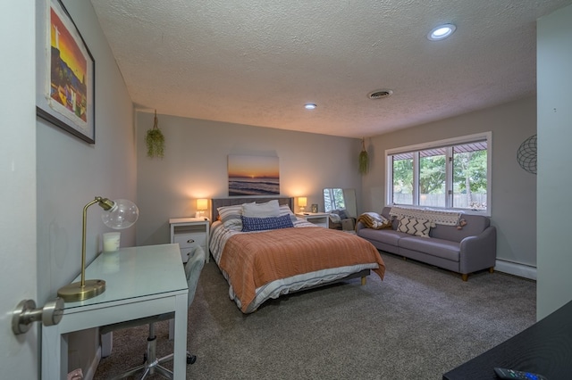 carpeted bedroom featuring a textured ceiling and a baseboard heating unit