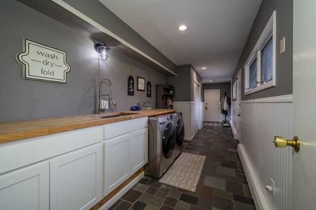 laundry area featuring cabinets, independent washer and dryer, and sink