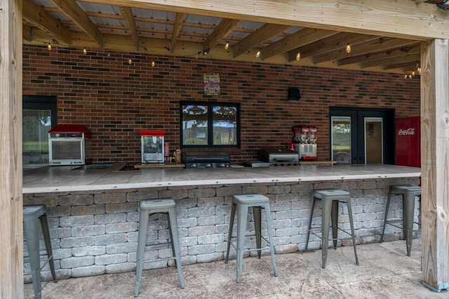 view of patio with area for grilling and an outdoor bar