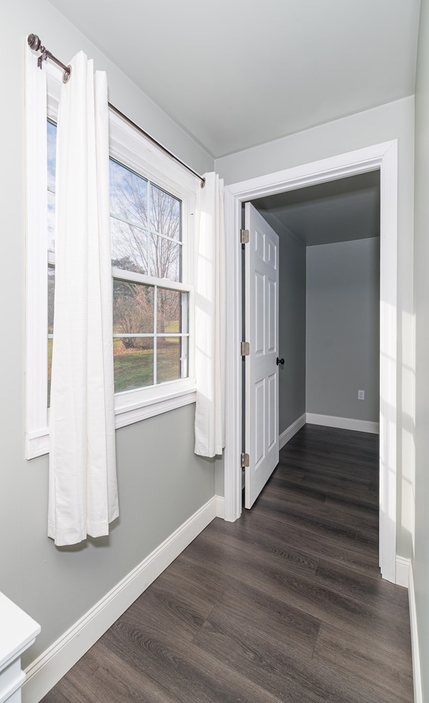 hall with dark hardwood / wood-style flooring