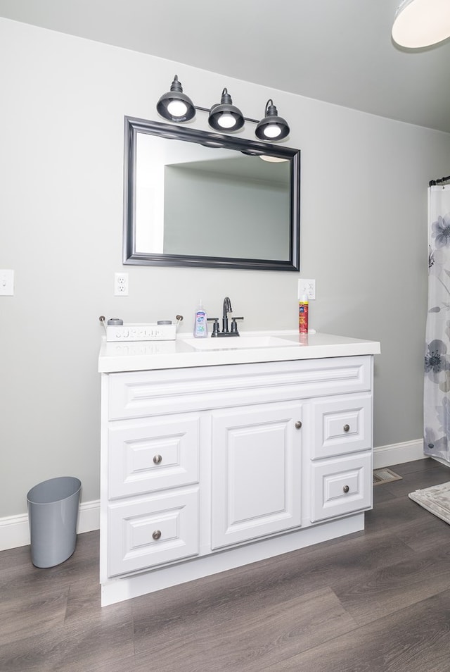 bathroom with hardwood / wood-style floors, vanity, and a shower with shower curtain