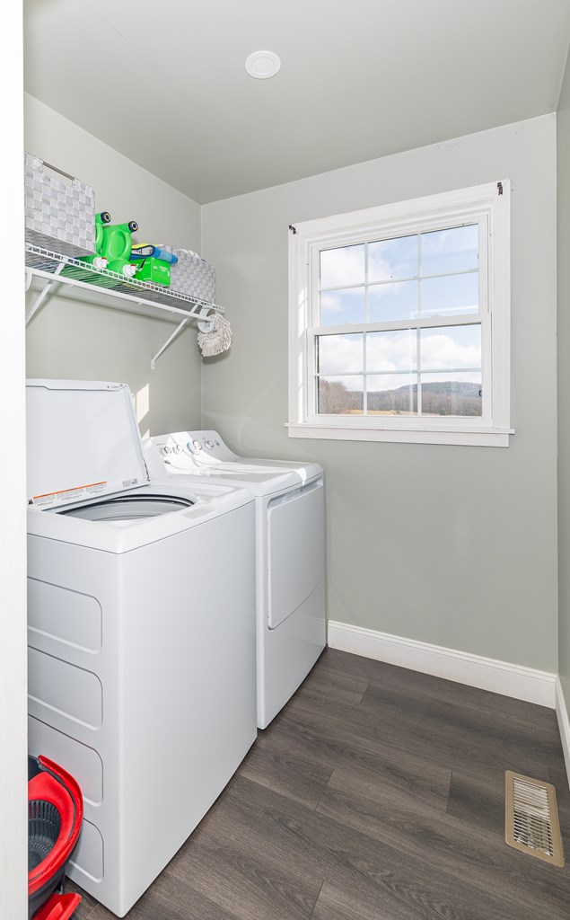 washroom with dark hardwood / wood-style flooring and separate washer and dryer