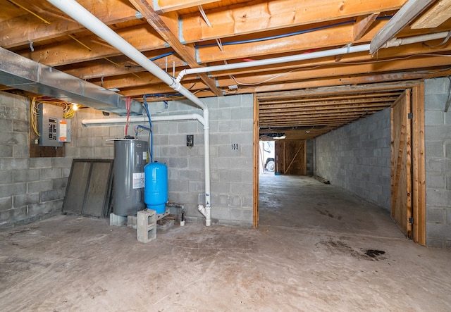 basement featuring electric water heater and electric panel