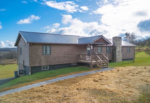 view of front of property featuring central AC unit and a front lawn