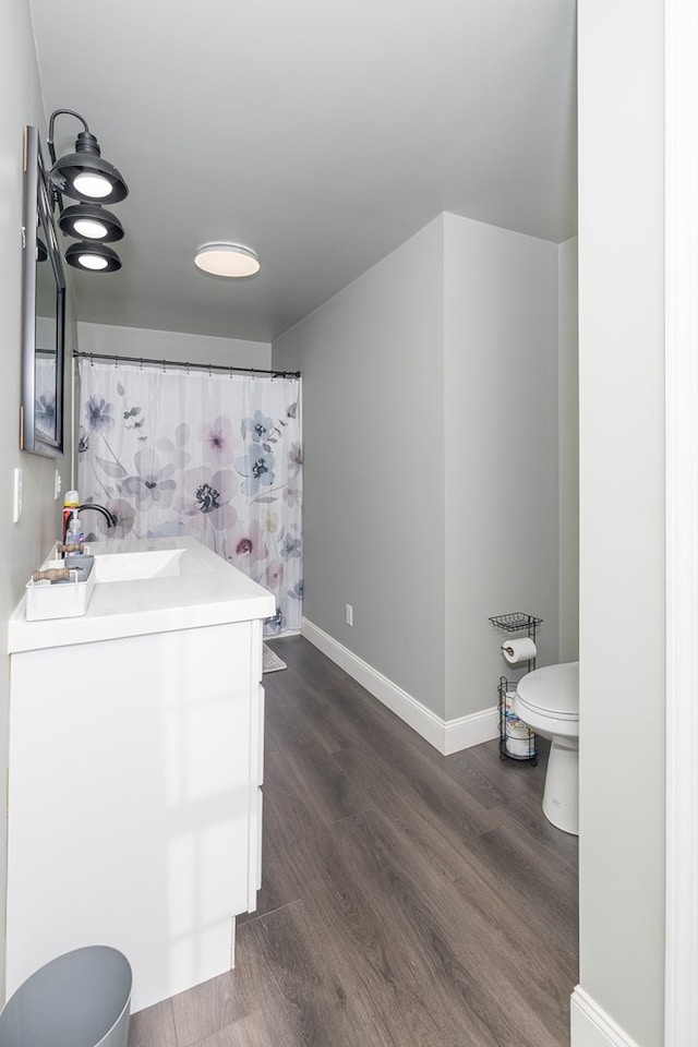 bathroom featuring hardwood / wood-style floors, vanity, and toilet