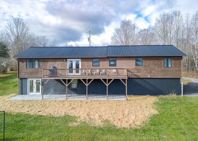 rear view of property featuring french doors, a deck, and a patio area