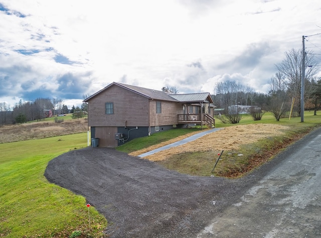 view of home's exterior featuring a garage and a lawn