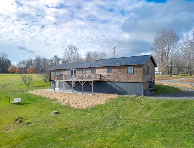 back of house with a lawn and a deck