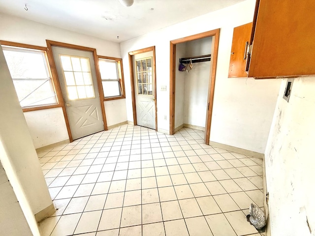 unfurnished bedroom with light tile patterned floors and a closet