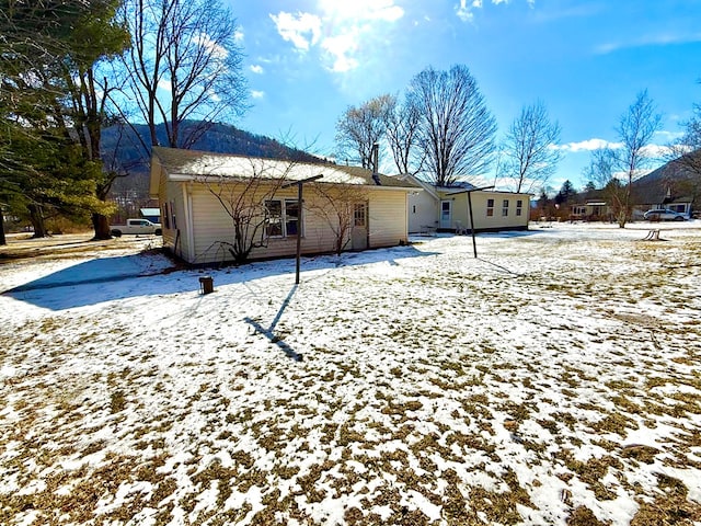 view of snow covered rear of property