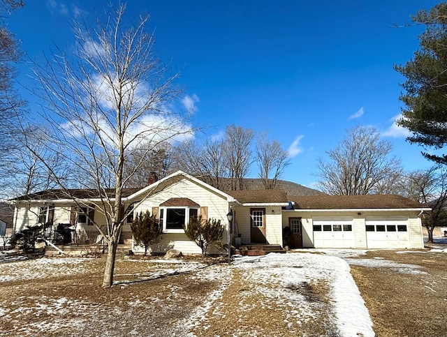 view of front of property with a porch and a garage