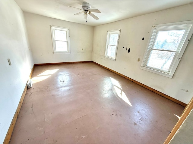 empty room featuring plenty of natural light and ceiling fan