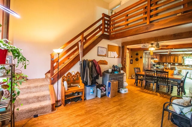 145 Tracy Brewer Rd, Meshoppen, PA 18630 - living area featuring stairway, wood finished floors, a ceiling fan, and a towering ceiling