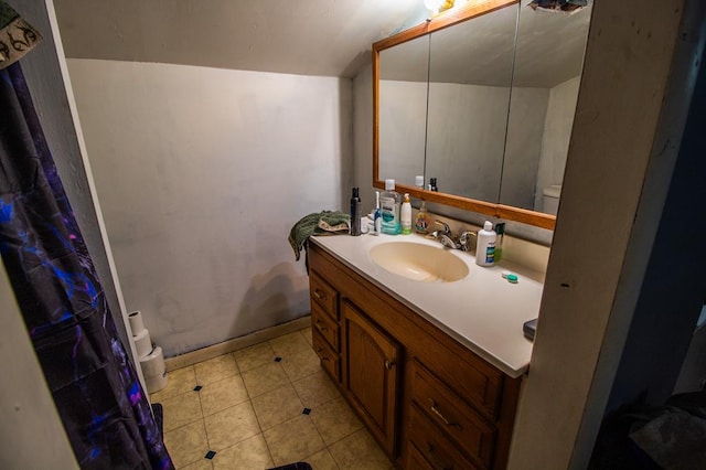 145 Tracy Brewer Rd, Meshoppen, PA 18630 - full bathroom with toilet, vanity, tile patterned floors, and vaulted ceiling