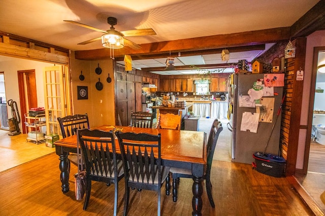 145 Tracy Brewer Rd, Meshoppen, PA 18630 - dining space featuring a ceiling fan, beamed ceiling, wood finished floors, and wood walls