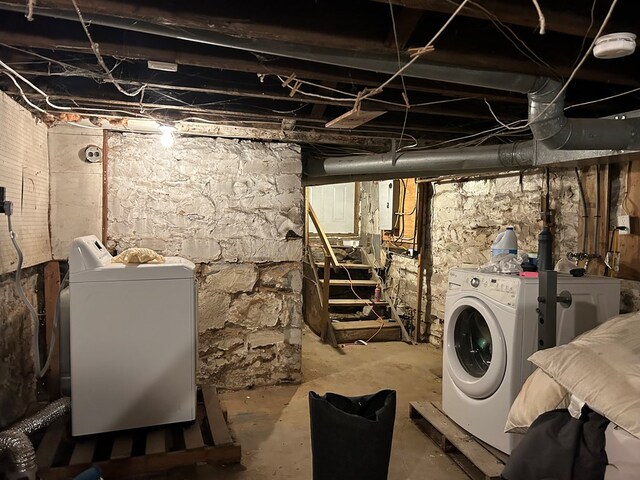 basement with washer and clothes dryer and electric panel