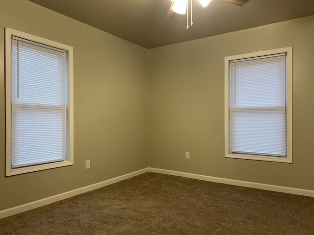 carpeted spare room with ceiling fan