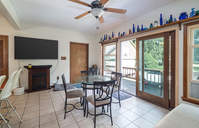 dining space with light tile patterned floors and ceiling fan