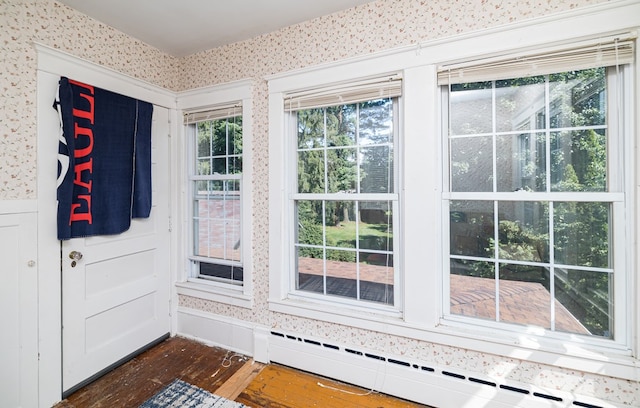 doorway featuring dark hardwood / wood-style floors and a baseboard heating unit