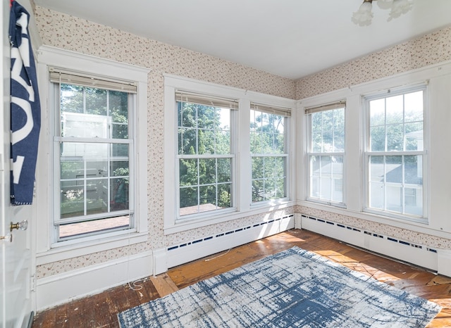 unfurnished sunroom featuring a baseboard radiator