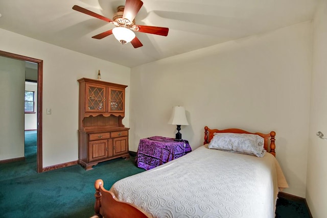 bedroom with ceiling fan and dark colored carpet