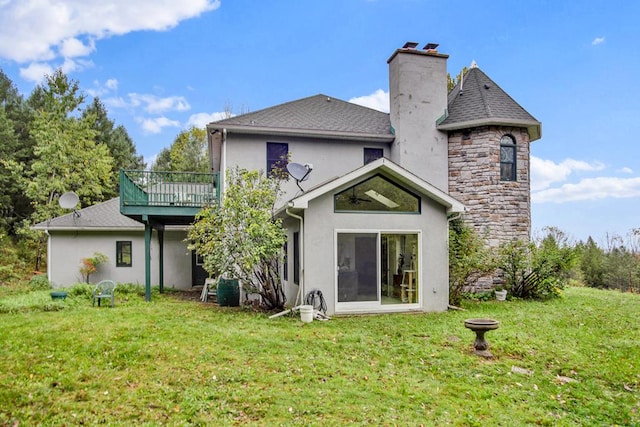 rear view of property featuring a yard