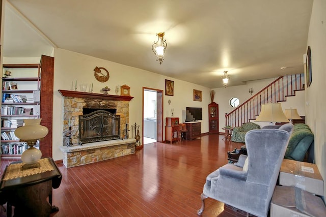 living room featuring hardwood / wood-style floors and a stone fireplace