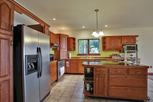 kitchen featuring hanging light fixtures, sink, light tile patterned floors, appliances with stainless steel finishes, and a chandelier