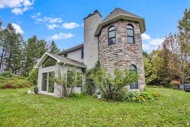 view of property exterior featuring a lawn