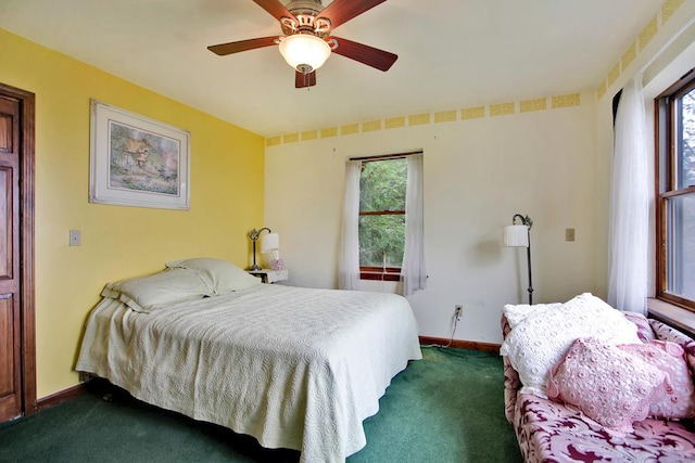 bedroom with dark colored carpet and ceiling fan