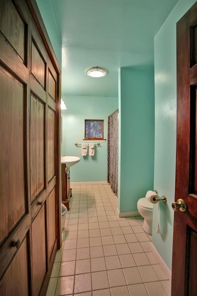 bathroom featuring tile patterned flooring, vanity, and toilet