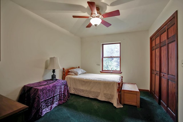 bedroom featuring dark colored carpet, a closet, and ceiling fan