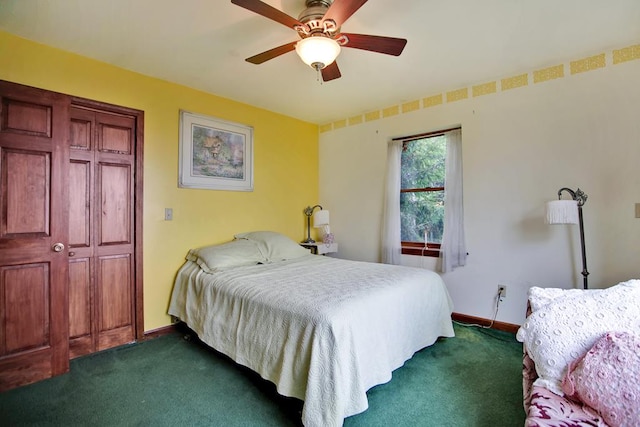 carpeted bedroom featuring ceiling fan and a closet