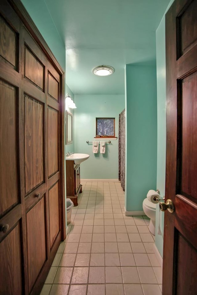 bathroom featuring tile patterned floors, vanity, and toilet