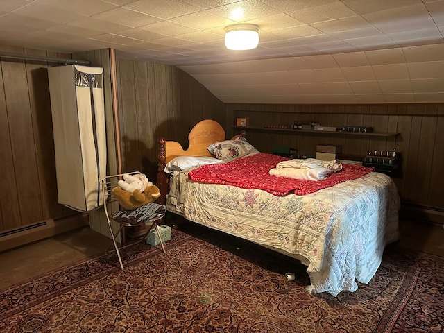 bedroom with vaulted ceiling and wooden walls