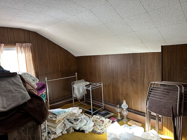 bonus room featuring lofted ceiling and wood walls