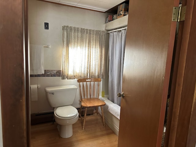 bathroom with shower / bathtub combination with curtain, toilet, wood-type flooring, and baseboard heating